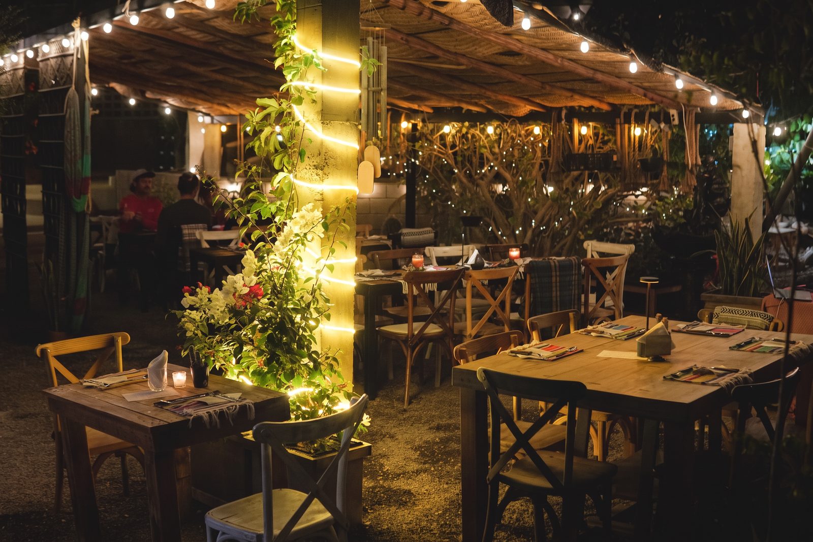 Cebollajo's garden terrace set for dinner at night