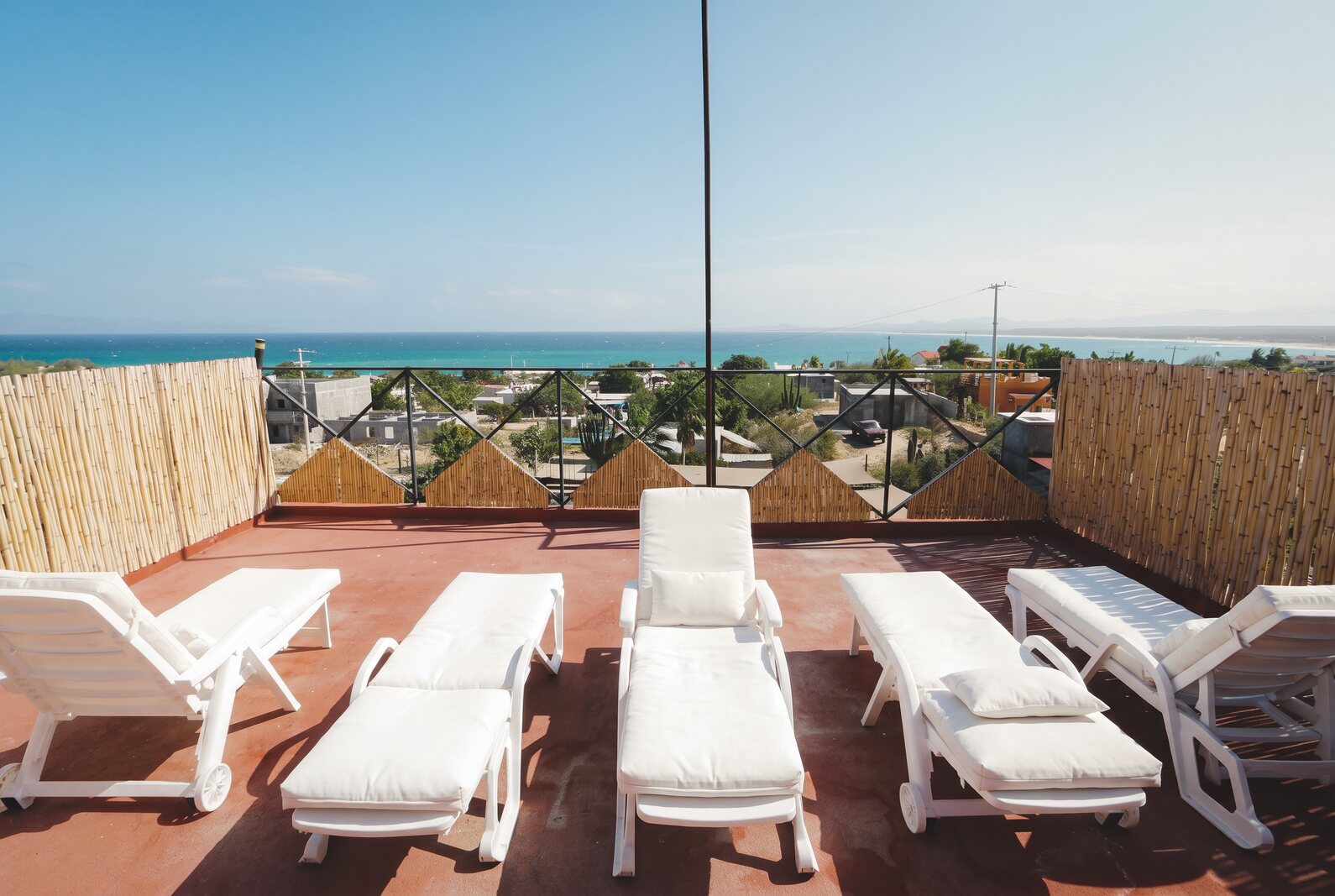 The rooftop terrace with loungers overlooking the bay